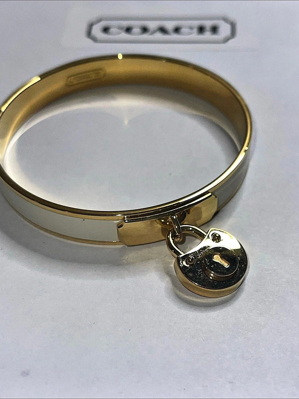 Coach Iconic Padlock Bangle Bracelet in Gold and White